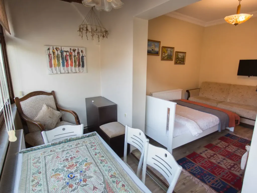 A second sleeping area with armchairs and kilim rugs