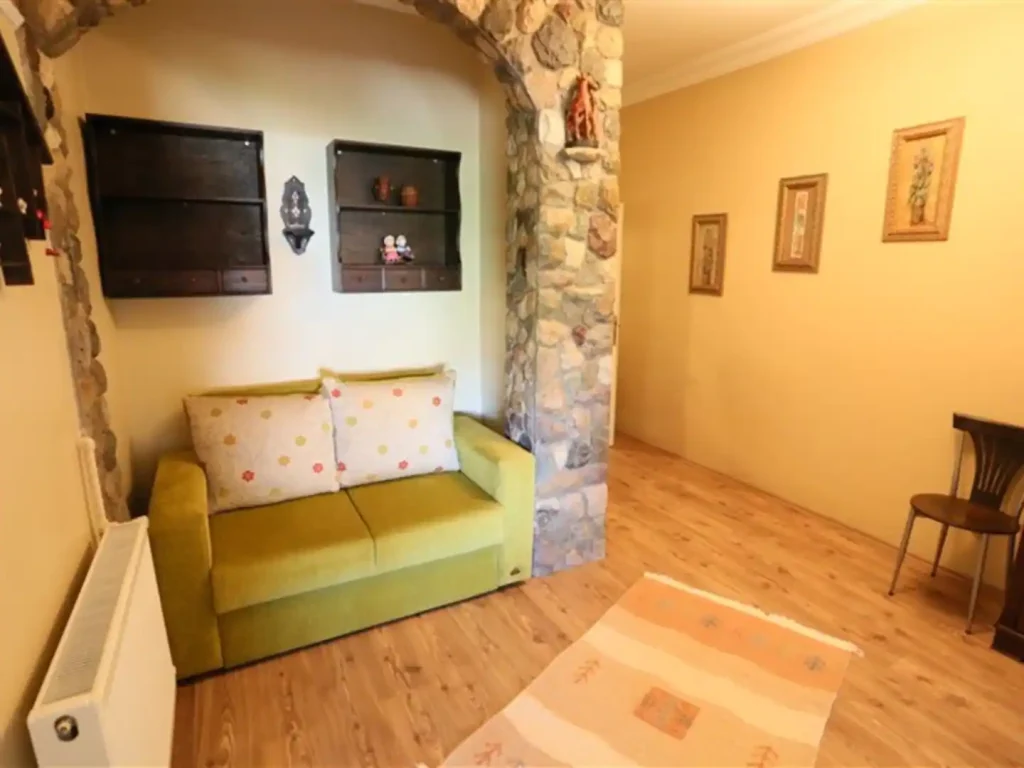 A sitting corner against the exposed stone wall