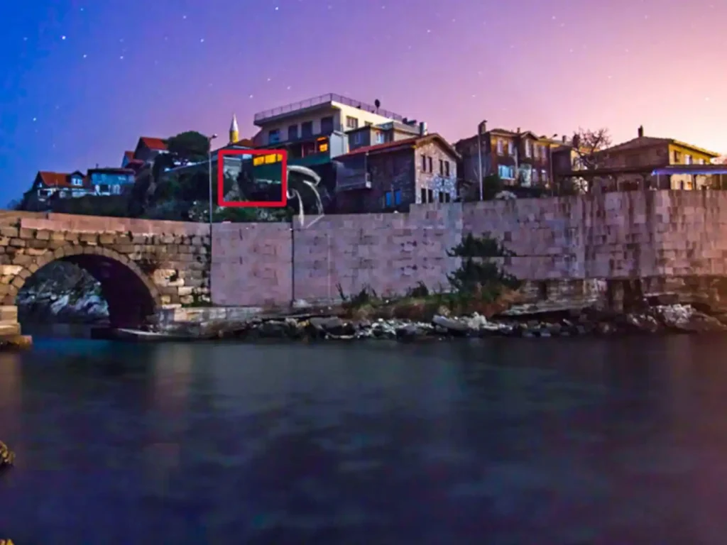 Amasra by night, the castle walls lit above the water