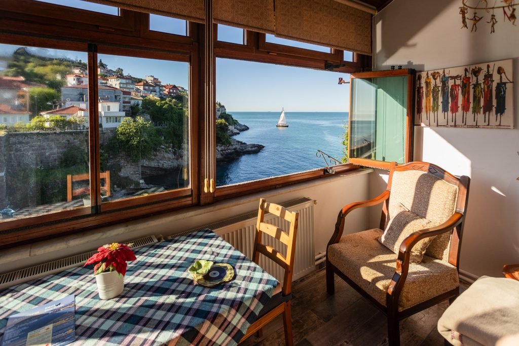 The sea-view sitting room, with sailing boats passing below
